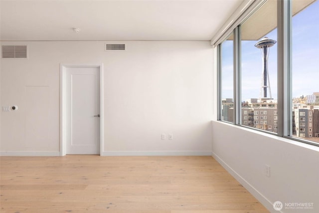 2510 6th Ave Unit 809, Seattle, WA 98121 - empty room featuring light wood-type flooring and a city view