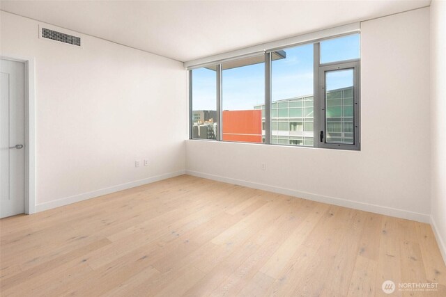 2510 6th Ave Unit 809, Seattle, WA 98121 - unfurnished room with hardwood / wood-style flooring and baseboards