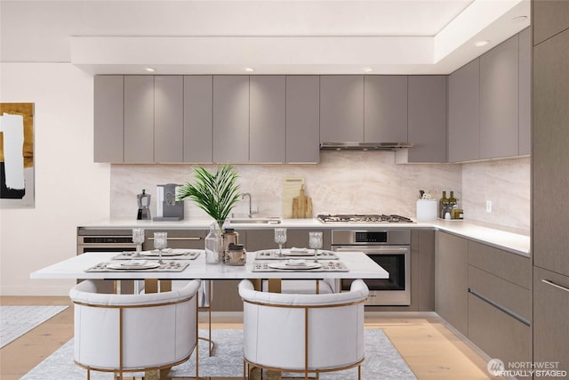 2510 6th Ave Unit 809, Seattle, WA 98121 - kitchen featuring stainless steel appliances, gray cabinetry, modern cabinets, light wood-type flooring, and recessed lighting