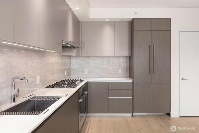 2510 6th Ave Unit 809, Seattle, WA 98121 - kitchen with stainless steel appliances, modern cabinets, gray cabinetry, light countertops, and recessed lighting