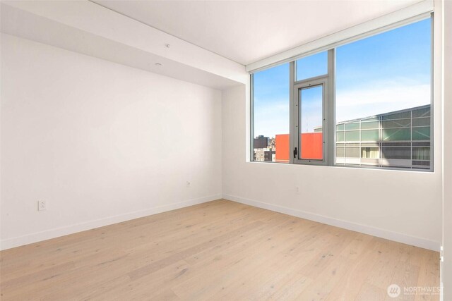 2510 6th Ave Unit 809, Seattle, WA 98121 - empty room with baseboards and wood finished floors