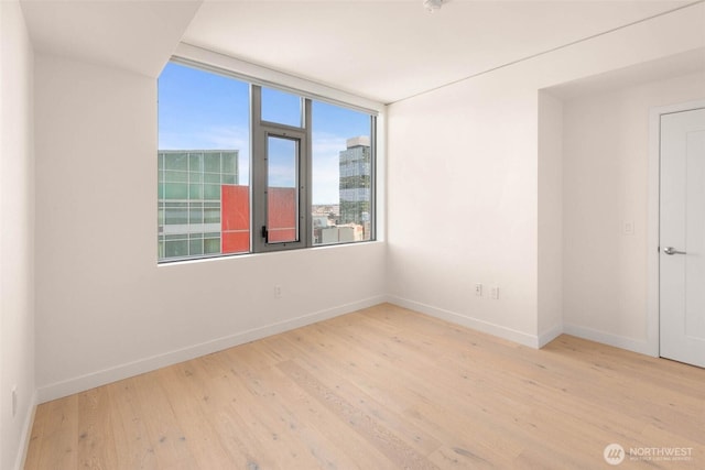 2510 6th Ave Unit 809, Seattle, WA 98121 - unfurnished room featuring wood finished floors and baseboards