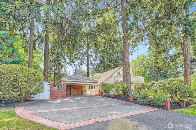 3706 84th Ave SE, Mercer Island, WA 98040 - view of front of house featuring driveway, a carport, view of scattered trees, and brick siding