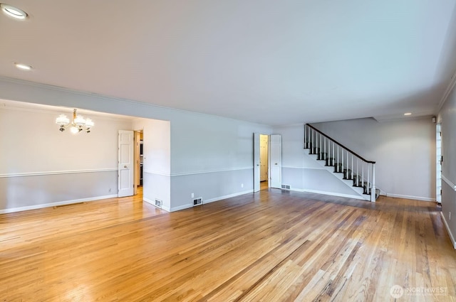 3706 84th Ave SE, Mercer Island, WA 98040 - unfurnished living room featuring stairway, a chandelier, light wood-style flooring, recessed lighting, and crown molding