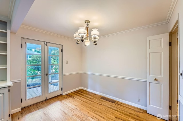 3706 84th Ave SE, Mercer Island, WA 98040 - unfurnished room with a chandelier, light wood-type flooring, ornamental molding, and french doors