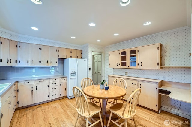 3706 84th Ave SE, Mercer Island, WA 98040 - kitchen featuring white fridge with ice dispenser, crown molding, light wood-style floors, backsplash, and light countertops
