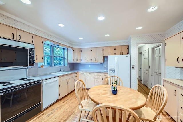 3706 84th Ave SE, Mercer Island, WA 98040 - kitchen with white appliances, ornamental molding, light wood-style floors, wallpapered walls, and light countertops