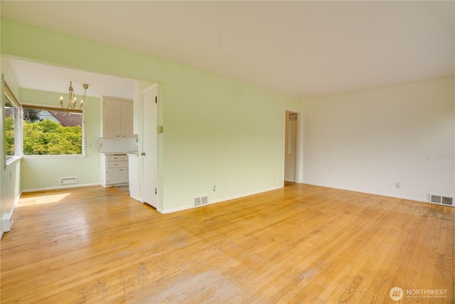 2602 Mccarver St, Tacoma, WA 98403 - unfurnished room with a chandelier and light wood finished floors