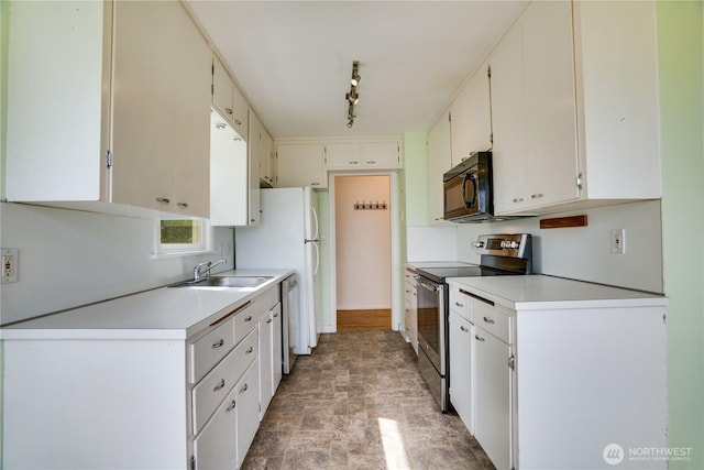 2602 Mccarver St, Tacoma, WA 98403 - kitchen with appliances with stainless steel finishes, light countertops, stone finish flooring, and track lighting