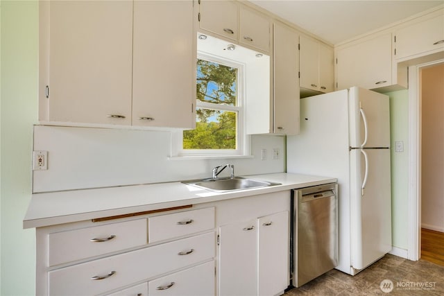 2602 Mccarver St, Tacoma, WA 98403 - kitchen featuring stainless steel dishwasher, light countertops, and freestanding refrigerator