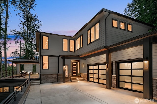 17750 SE 63rd Pl, Bellevue, WA 98006 - view of front of property featuring an attached garage, stone siding, and driveway