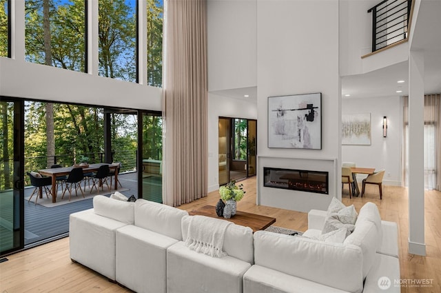 17750 SE 63rd Pl, Bellevue, WA 98006 - living area featuring a towering ceiling, a glass covered fireplace, and wood finished floors