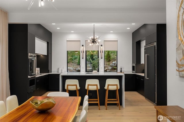17750 SE 63rd Pl, Bellevue, WA 98006 - dining space featuring a chandelier, light wood-style floors, and recessed lighting