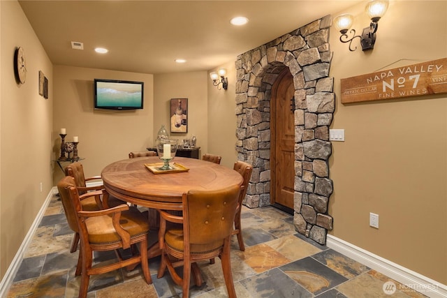 67 Cascade Ky, Bellevue, WA 98006 - dining space featuring stone finish flooring, arched walkways, and recessed lighting