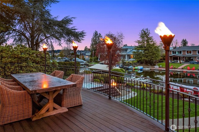 67 Cascade Ky, Bellevue, WA 98006 - deck at dusk with outdoor dining space and a lawn