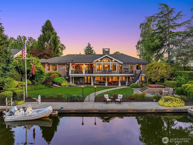 67 Cascade Ky, Bellevue, WA 98006 - rear view of house featuring a fenced backyard, a patio area, a water view, stairway, and a chimney
