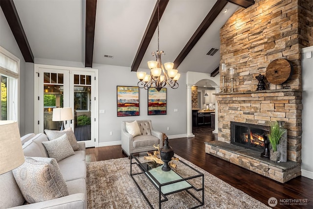 67 Cascade Ky, Bellevue, WA 98006 - living area featuring arched walkways, wood finished floors, a chandelier, and a stone fireplace