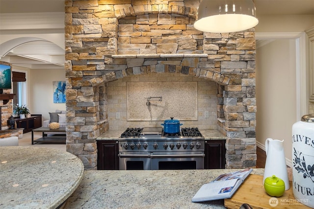 67 Cascade Ky, Bellevue, WA 98006 - kitchen with high end stainless steel range oven, arched walkways, light stone counters, beam ceiling, and tasteful backsplash