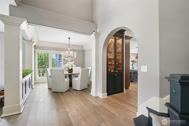 4706 NE 137th St NE, Vancouver, WA 98686 - dining space with light wood-style floors, a chandelier, and arched walkways