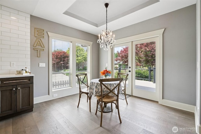 4706 NE 137th St NE, Vancouver, WA 98686 - dining room with light wood-style flooring, a chandelier, and a tray ceiling