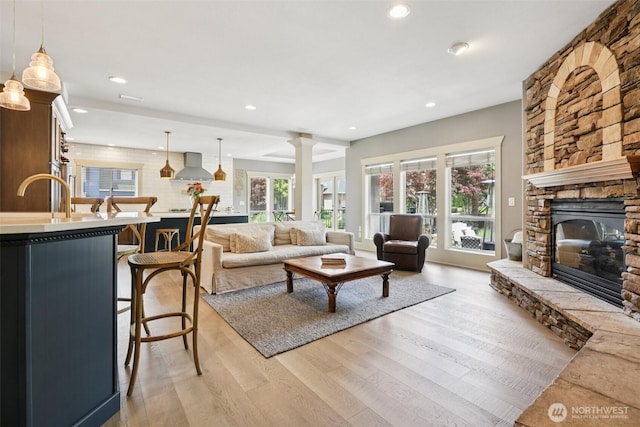 4706 NE 137th St NE, Vancouver, WA 98686 - living room with light wood-style flooring, recessed lighting, a fireplace, and decorative columns