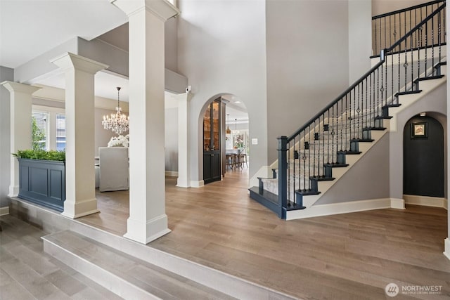 4706 NE 137th St NE, Vancouver, WA 98686 - entrance foyer featuring ornate columns, wood finished floors, stairway, arched walkways, and a high ceiling