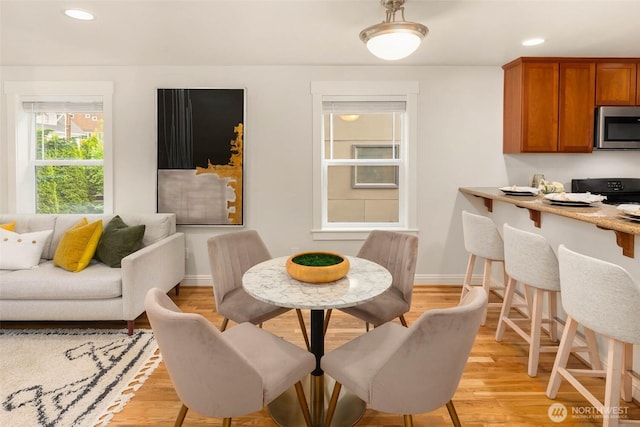 5235 11th Ave NE Unit A, Seattle, WA 98105 - dining room with light wood-style floors and recessed lighting