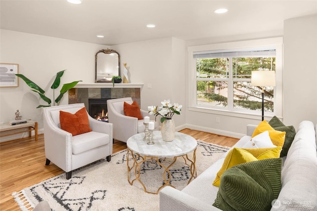 5235 11th Ave NE Unit A, Seattle, WA 98105 - living room with wood finished floors, a tile fireplace, and recessed lighting