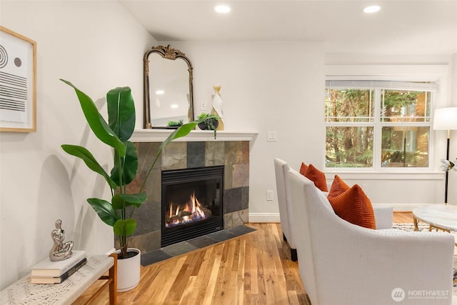 5235 11th Ave NE Unit A, Seattle, WA 98105 - living room with a tile fireplace, wood finished floors, and recessed lighting