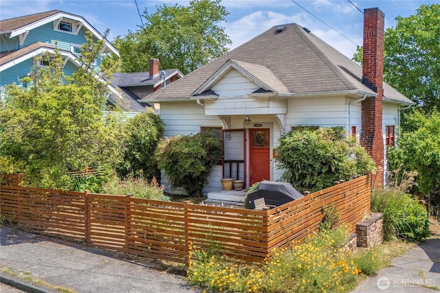 4228 1st Ave NE, Seattle, WA 98105 - view of front facade featuring a chimney and a fenced front yard