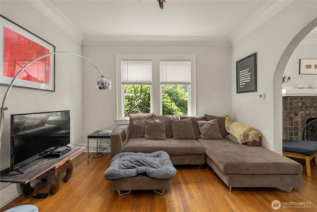 4228 1st Ave NE, Seattle, WA 98105 - living room featuring arched walkways, wood finished floors, and ornamental molding