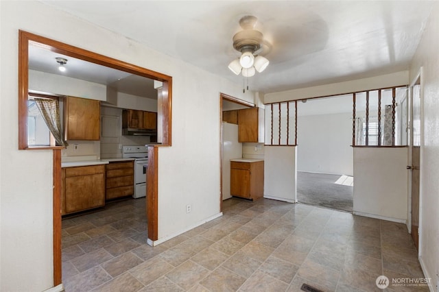 832 S 2nd Ave, Othello, WA 99344 - kitchen with electric range, brown cabinets, ceiling fan, light stone finish flooring, and light countertops