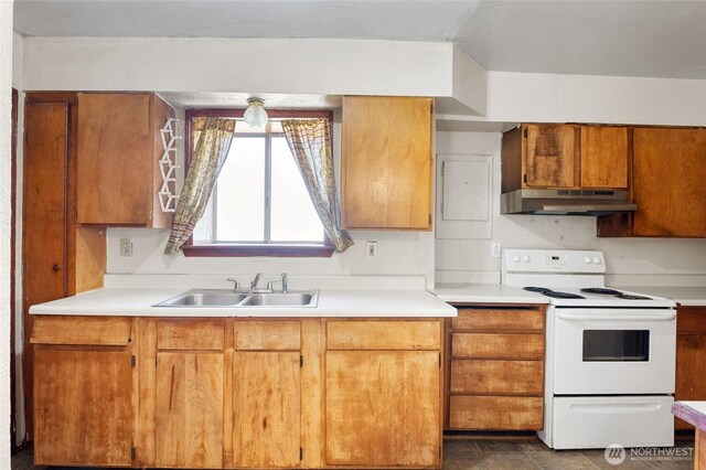 832 S 2nd Ave, Othello, WA 99344 - kitchen featuring white range with electric cooktop, under cabinet range hood, light countertops, and brown cabinetry