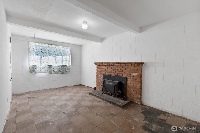 832 S 2nd Ave, Othello, WA 99344 - unfurnished living room with a wood stove, beam ceiling, and tile walls