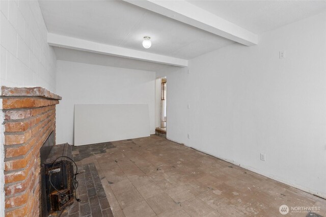 832 S 2nd Ave, Othello, WA 99344 - unfurnished living room featuring beamed ceiling and a wood stove