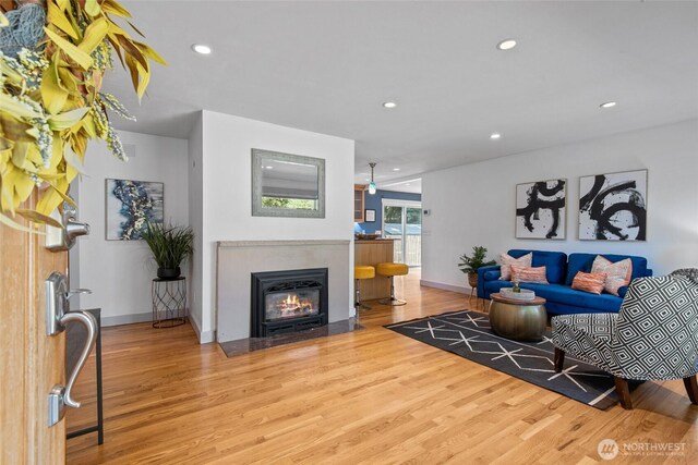 19515 7th Ave NE, Shoreline, WA 98155 - living area with wood finished floors, a fireplace with flush hearth, and recessed lighting