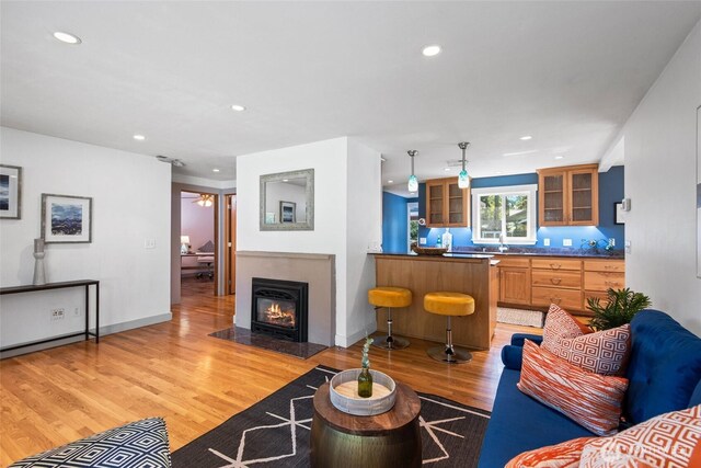19515 7th Ave NE, Shoreline, WA 98155 - living area featuring light wood finished floors, recessed lighting, and a fireplace with flush hearth