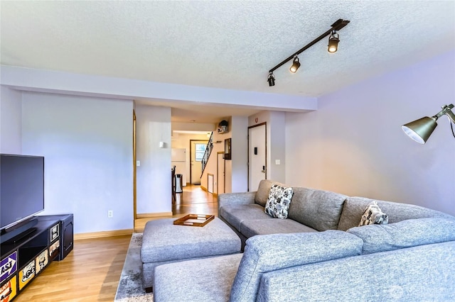 8605 244th St SW Unit 3F, Edmonds, WA 98026 - living room featuring light wood-type flooring and a textured ceiling