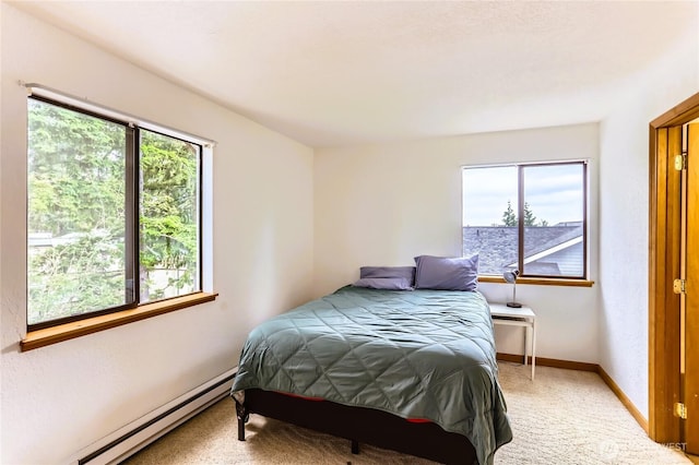 8605 244th St SW Unit 3F, Edmonds, WA 98026 - bedroom featuring baseboard heating, multiple windows, and light carpet