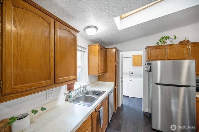 492 Hilltop Dr, Sedro Woolley, WA 98284 - kitchen featuring appliances with stainless steel finishes, separate washer and dryer, dark wood-style floors, light countertops, and a skylight