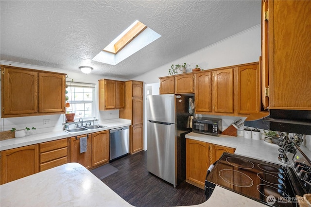 492 Hilltop Dr, Sedro Woolley, WA 98284 - kitchen featuring stainless steel appliances, vaulted ceiling, a skylight, dark wood-style flooring, and a textured ceiling