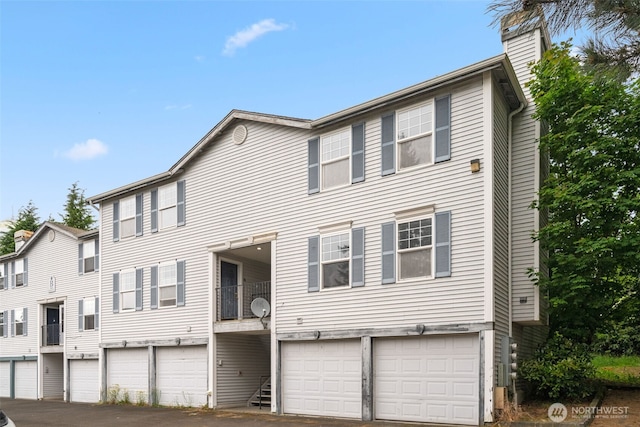 1160 Monroe Ave NE Unit B-4, Renton, WA 98056 - multi unit property featuring a chimney, a garage, and driveway