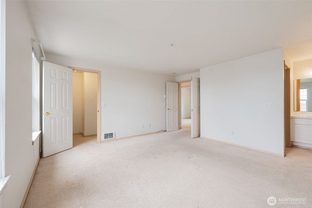 1160 Monroe Ave NE Unit B-4, Renton, WA 98056 - unfurnished bedroom with light colored carpet and baseboards