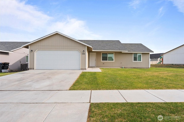 1325 W Polo Ridge Dr, Moses Lake, WA 98837 - single story home with a garage, driveway, a front yard, and a shingled roof