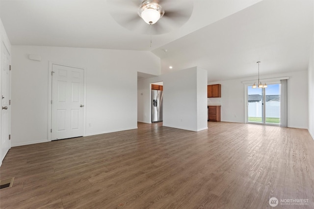 1325 W Polo Ridge Dr, Moses Lake, WA 98837 - unfurnished living room featuring a ceiling fan, lofted ceiling, a chandelier, and wood finished floors