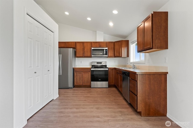 1325 W Polo Ridge Dr, Moses Lake, WA 98837 - kitchen with appliances with stainless steel finishes, lofted ceiling, recessed lighting, light wood-style floors, and light countertops