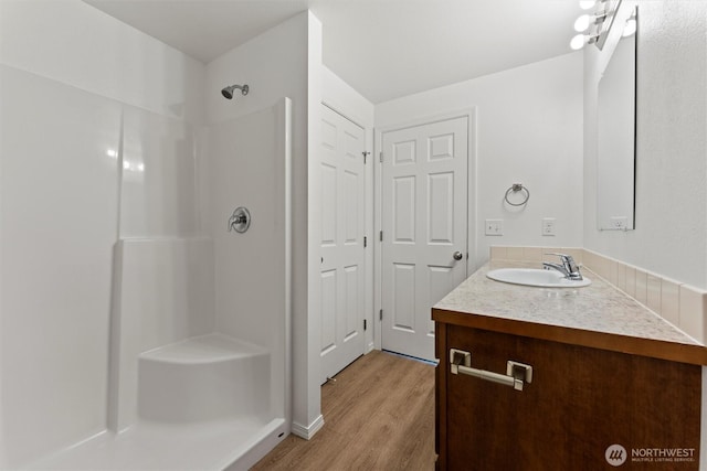 1325 W Polo Ridge Dr, Moses Lake, WA 98837 - full bathroom featuring a shower, vanity, and wood finished floors