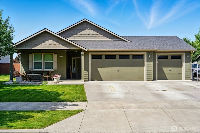 2134 Alco Ave, Walla Walla, WA 99362 - view of front of property featuring a garage, driveway, a front lawn, a shingled roof, and a porch
