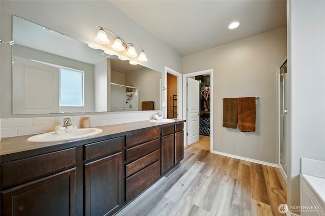 2134 Alco Ave, Walla Walla, WA 99362 - bathroom with a stall shower, a walk in closet, wood finished floors, and double vanity