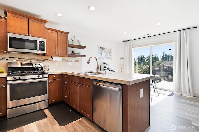 6672 Udall Pl SE, Auburn, WA 98092 - kitchen with appliances with stainless steel finishes, a peninsula, open shelves, light wood-style floors, and tasteful backsplash